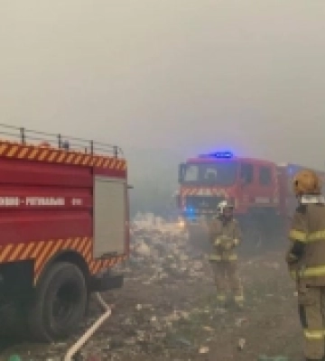 Біля Рівного, попри шквали, рятувальники гасять пожежу на звалищі