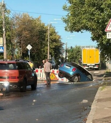 У Подільському районі Києва авто провалилося у яму через аварію на водогоні 
